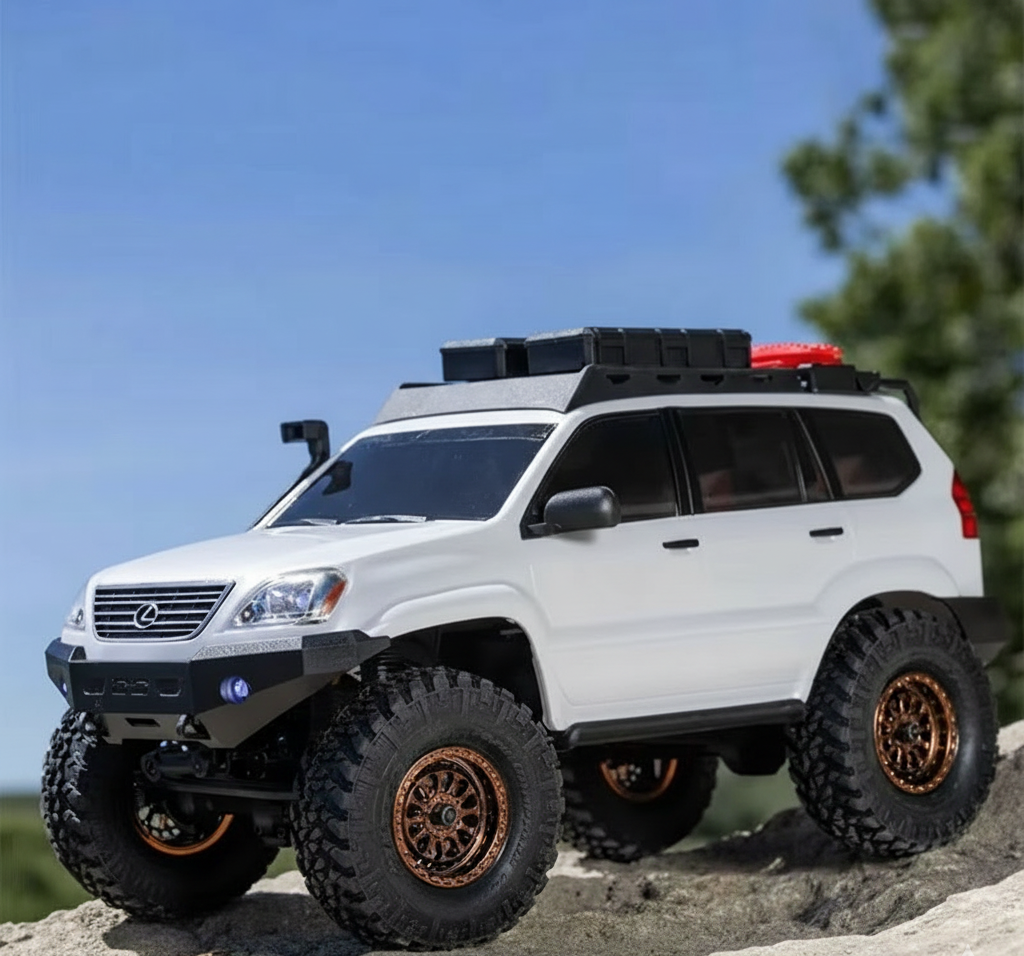 White off-road vehicle with large tires on a rocky surface